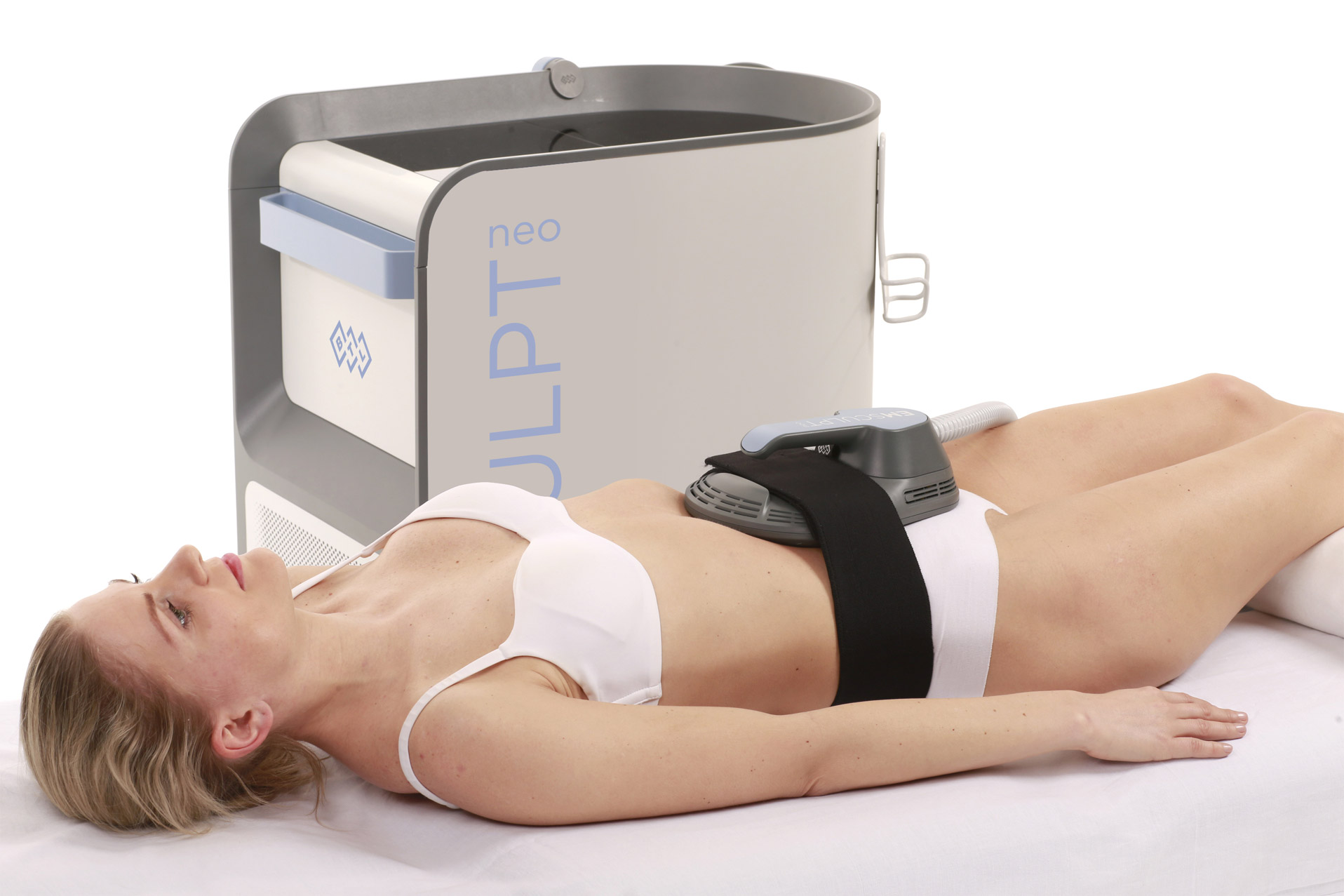 Woman undergoing Emsculpt Neo body contouring treatment with device applied to abdomen for muscle building and fat reduction.