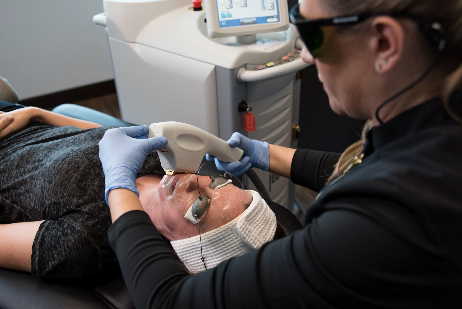 A skincare specialist performing a Halo Laser treatment on a patient’s face at Pure 111 Medical Aesthetics, using protective eyewear and advanced laser equipment.
